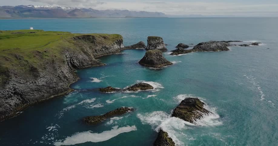 Aerial view of a hilly shore and large body of water