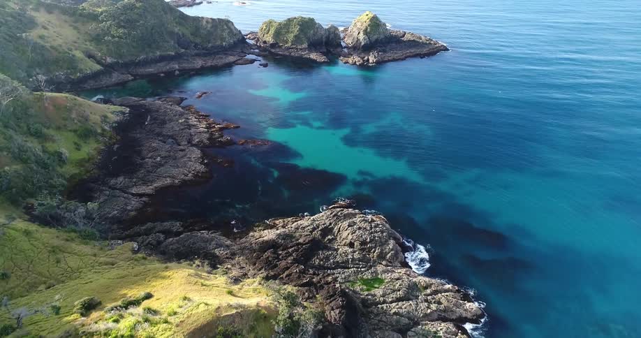A coastal landscape is shown on a sunny day