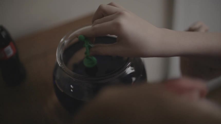 Person is planting something in a jar of dirt