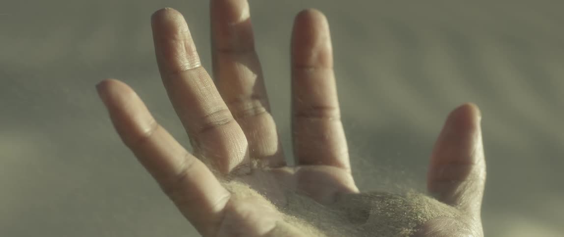 Sand blows off of an outstretched palm