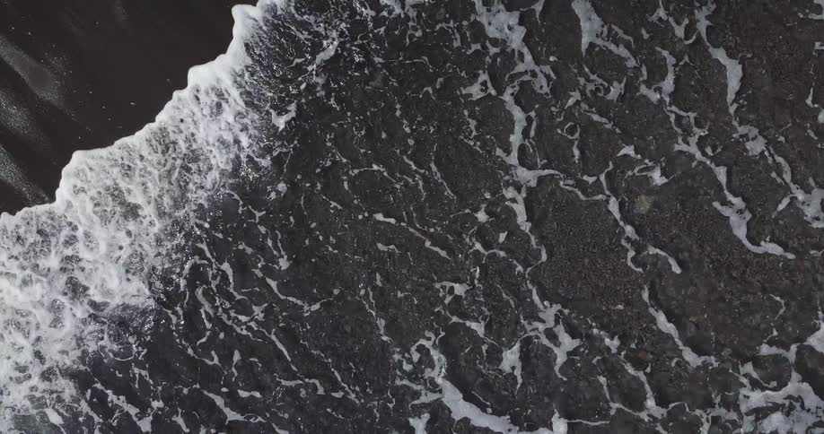 Aerial view of water splashing to shore