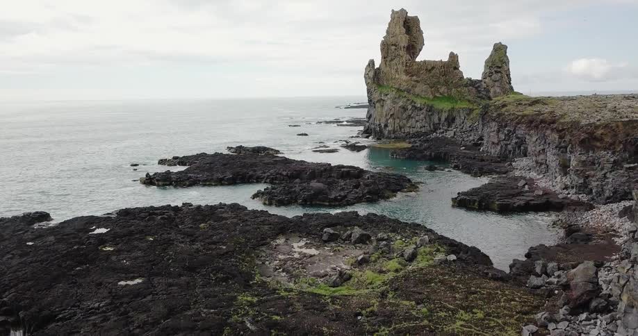 View of a rocky shoreline on a cloudy day