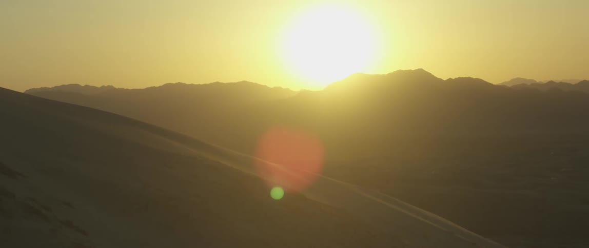 View of some hills with a bright sun in the sky