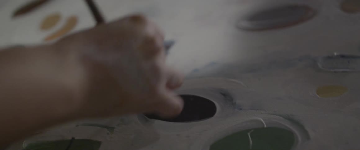 Person painting with a paint brush