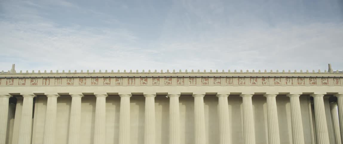 Cloudy sky moves down to a large building