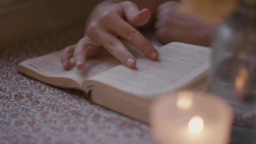 Person turning the pages of a book