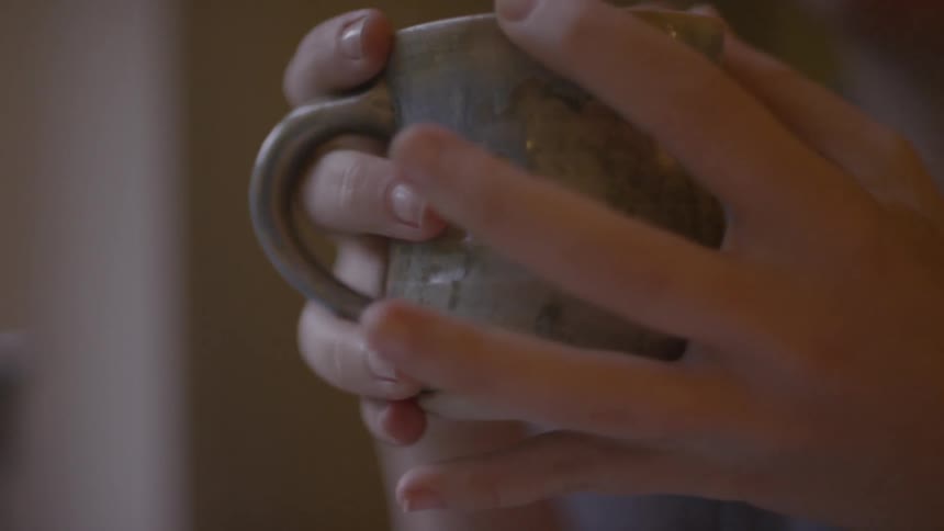 A person holding a mug