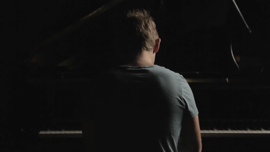 A boy is playing the piano