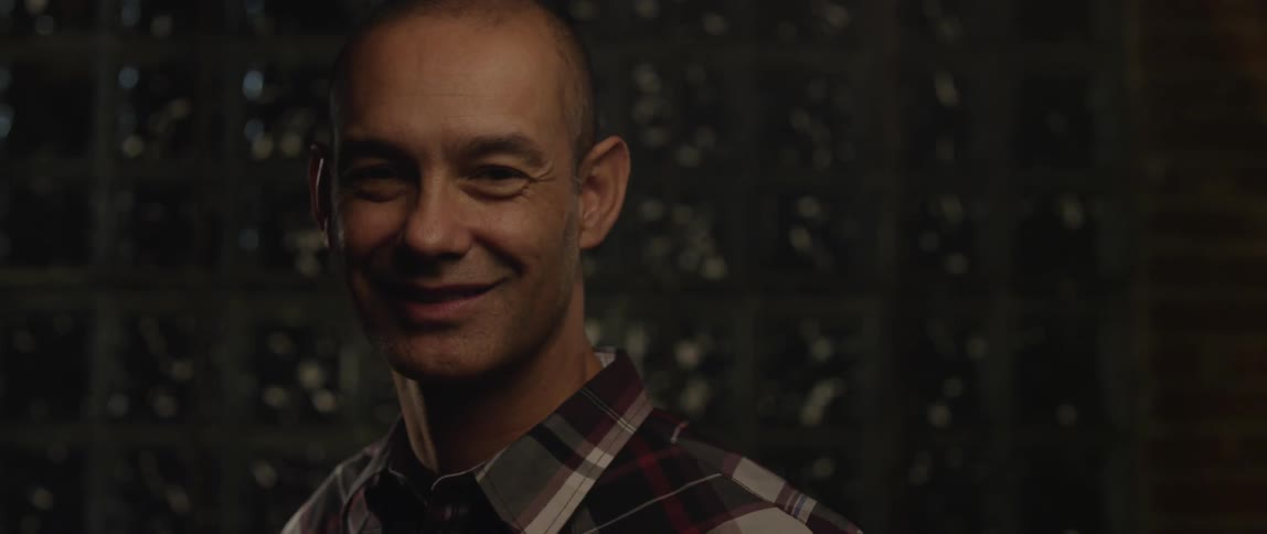 Man stares up and gives a bright smile