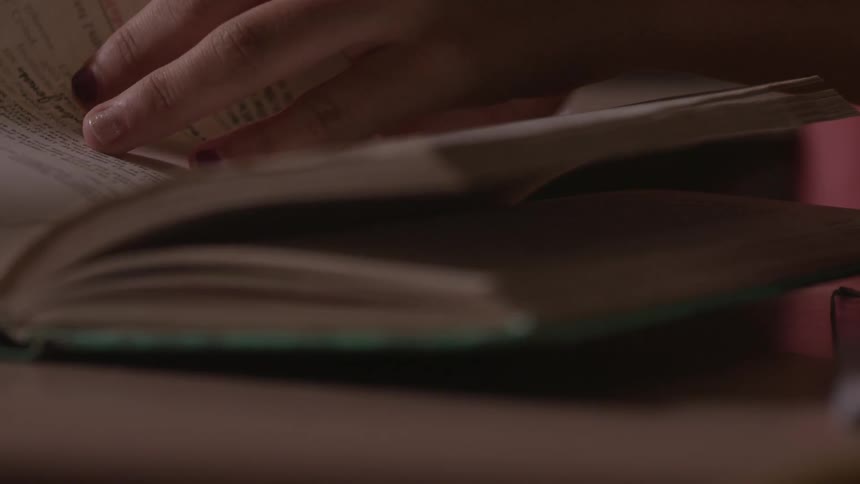 Person turning a page in a book that they are looking at