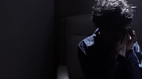 A person sitting in a shadow