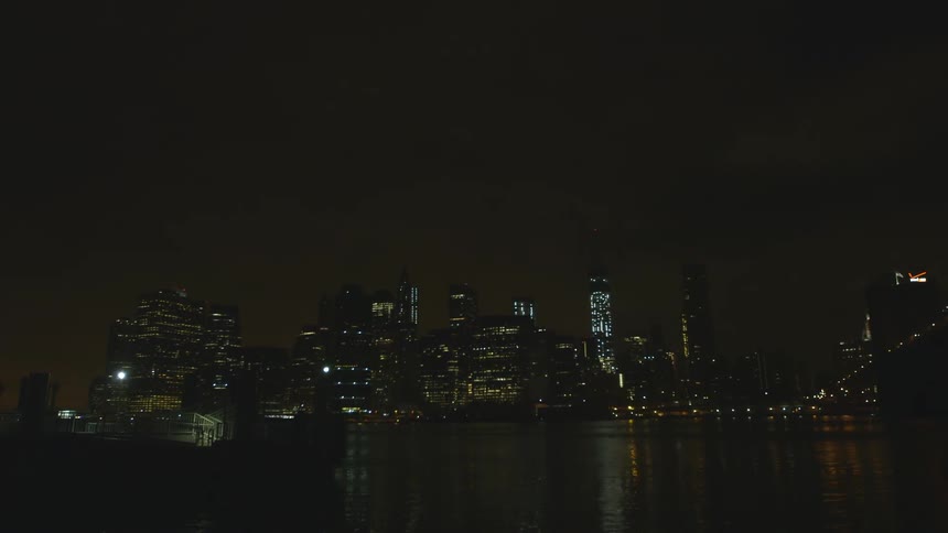 View over the water of a city at night