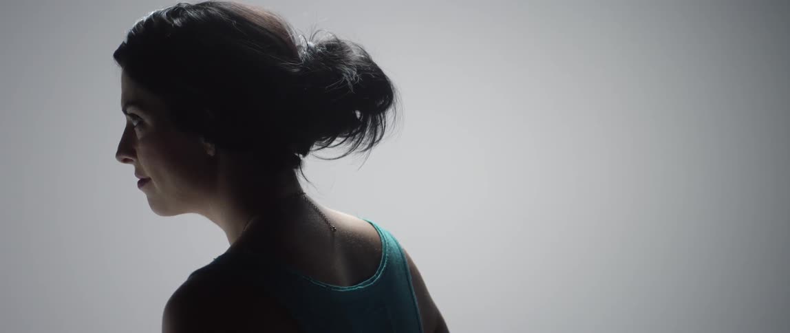 Woman looks up slowly smiling