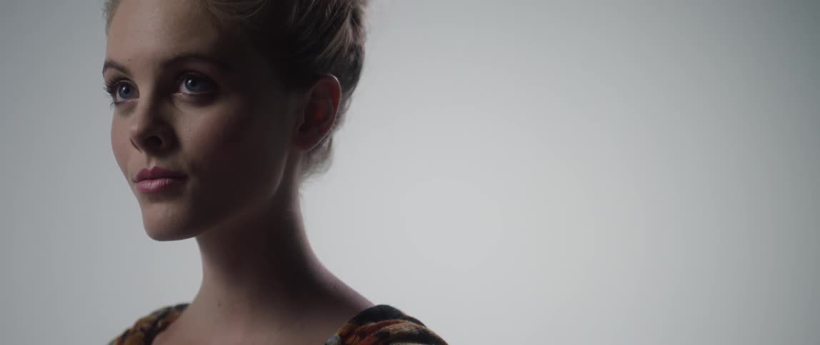 A young white female blinks and stares