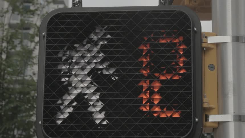 A crosswalk signal counts down