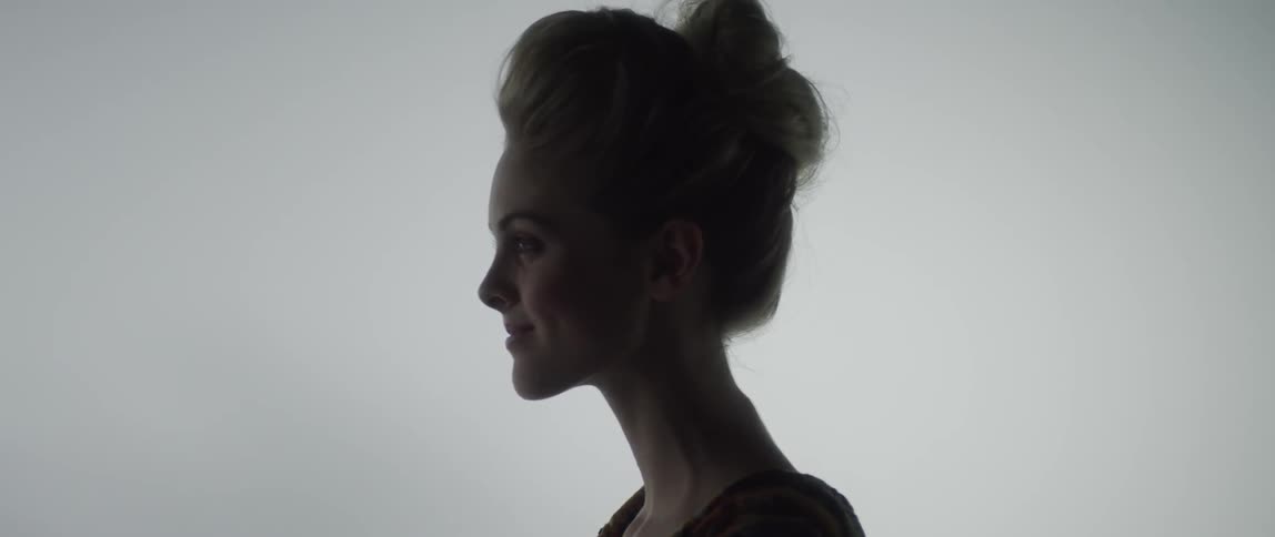 A woman looks up and smiles