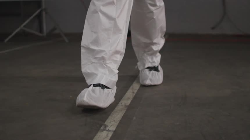 Person walks down a white line on a concrete floor