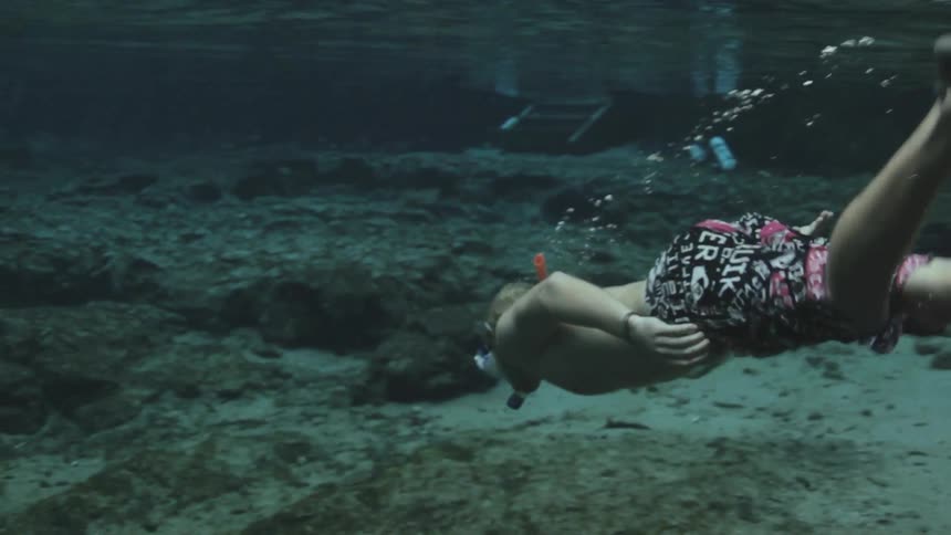 View of a person swimming underwater in the ocean