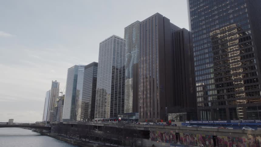 Cars drive by city skyscrapers