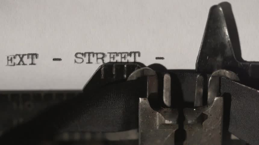 A typewriter typing out words on paper