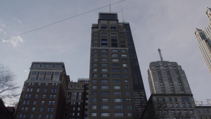 The buildings are very tall in this city on a sunny day