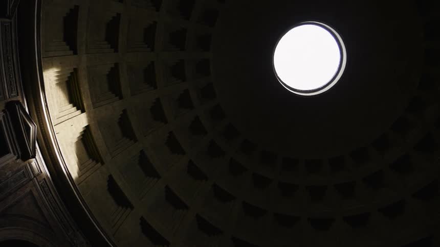 Sunlight shines on the interior stone work of a dome