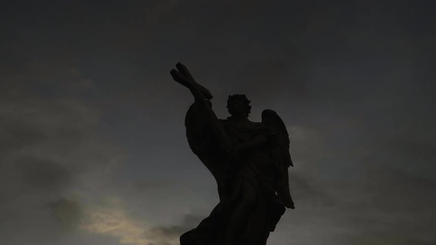 A statue of an angel holding a cross