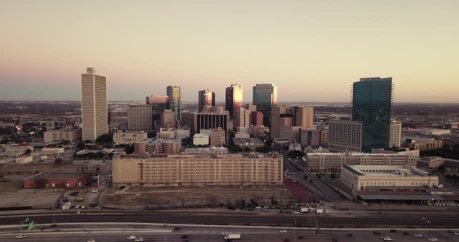 People are driving on the long road on the side of a city