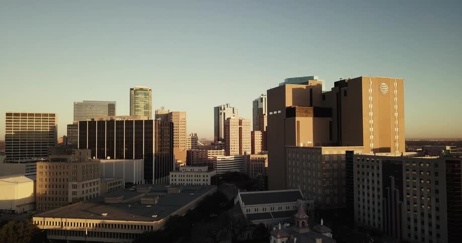 Buildings stand in a city on a clear day