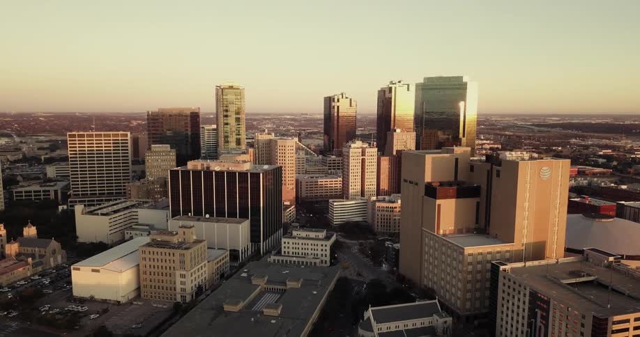 City skyscrapers are shown at sunset