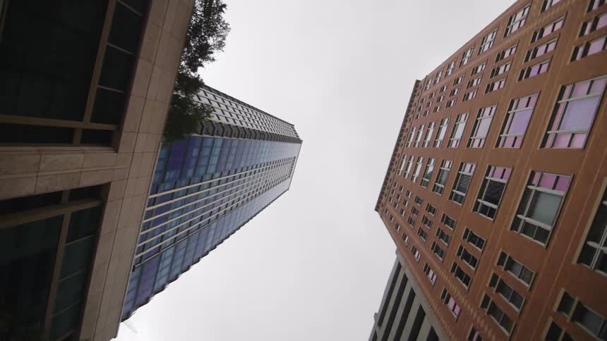 View looking up at skyscrapers on a cloudy day