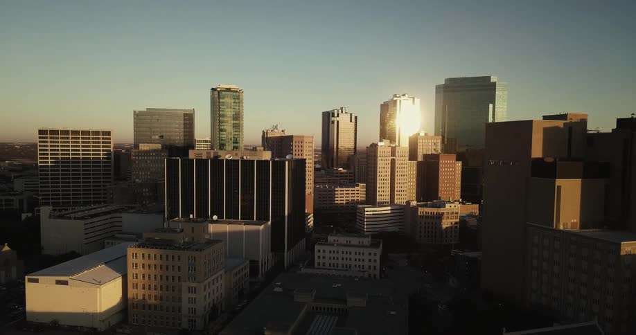 City buildings and skyscrapers are shown on a sunny day