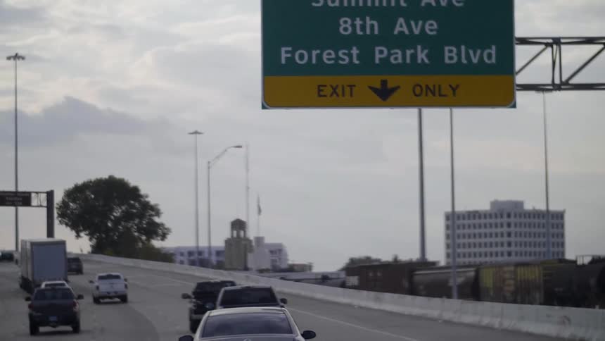 Cars drive on a city highway
