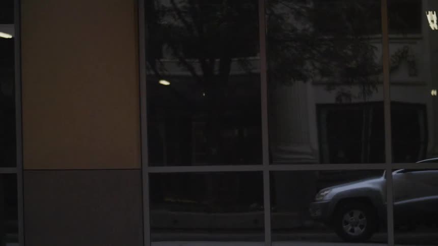 A person drives past a long building