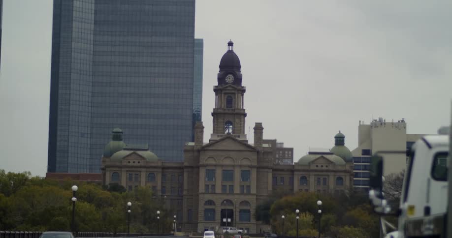 Truck drives down a city street towards the city capital building