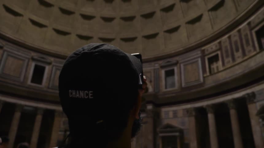 Man filming the inside of a tall building
