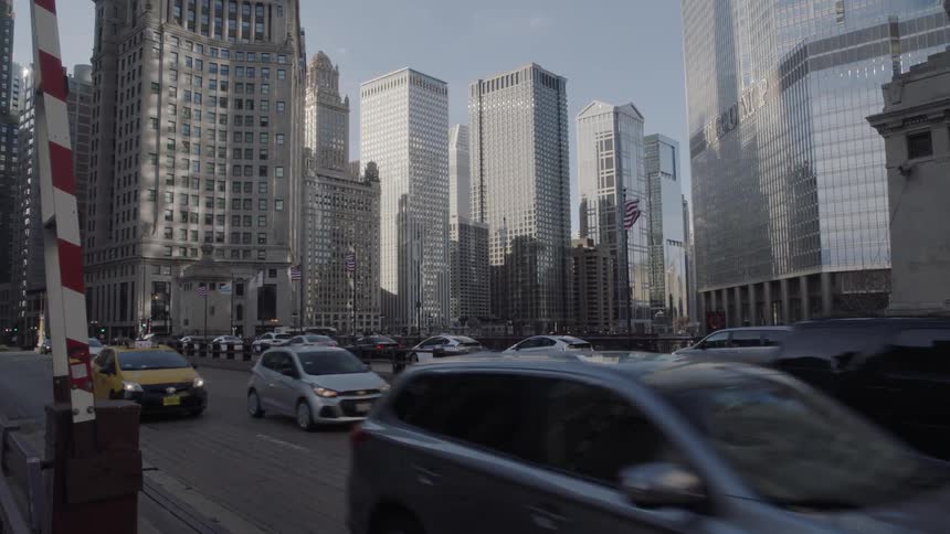 Cars driving down a busy street downtown