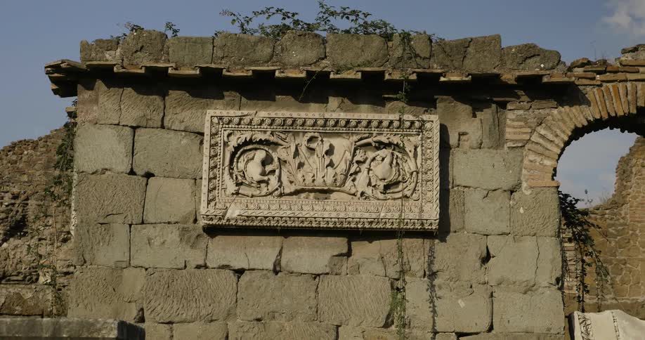 A carving sits on a stone wall