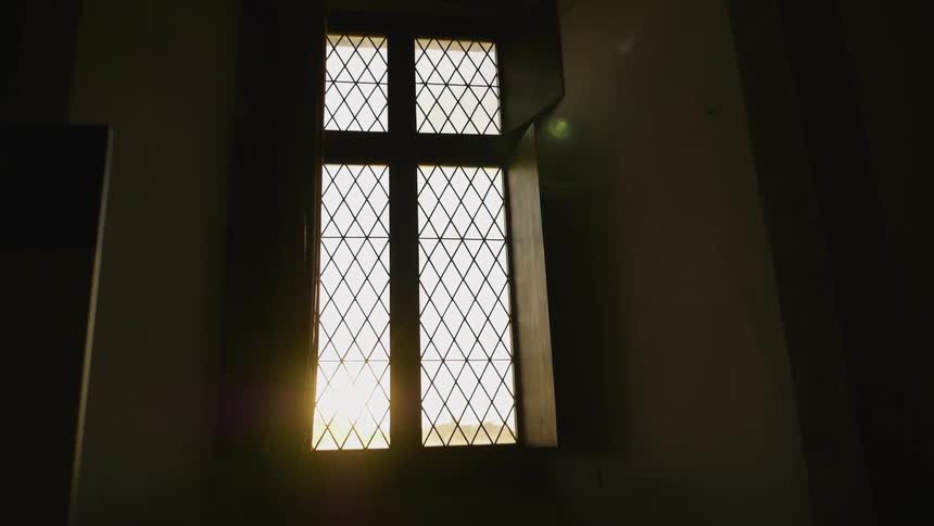The dark room leads to a large window