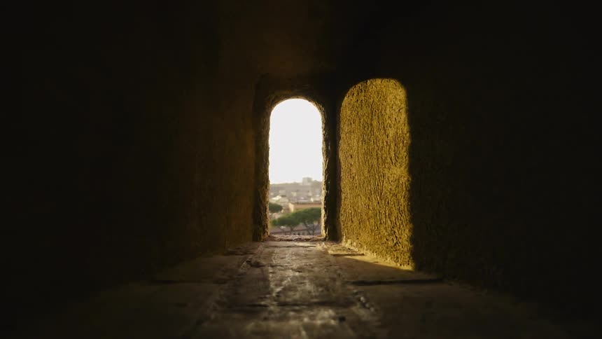 Light shines through an arched doorway