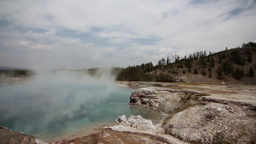 Steam coming off water in hot spring on cloudy day