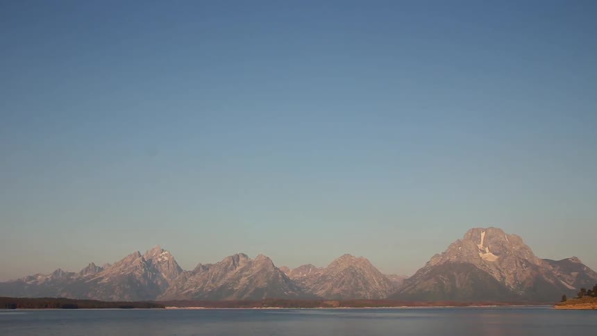 Water flows in a lake between mountains