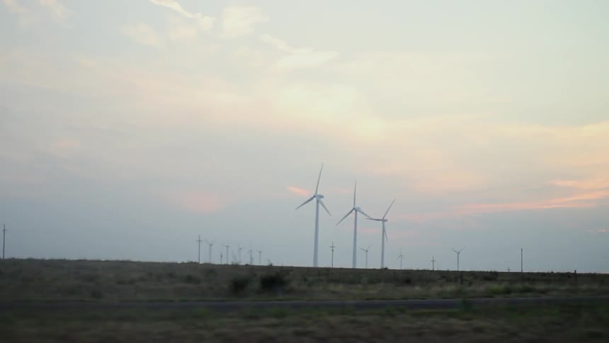 Windmills turning at sunrise