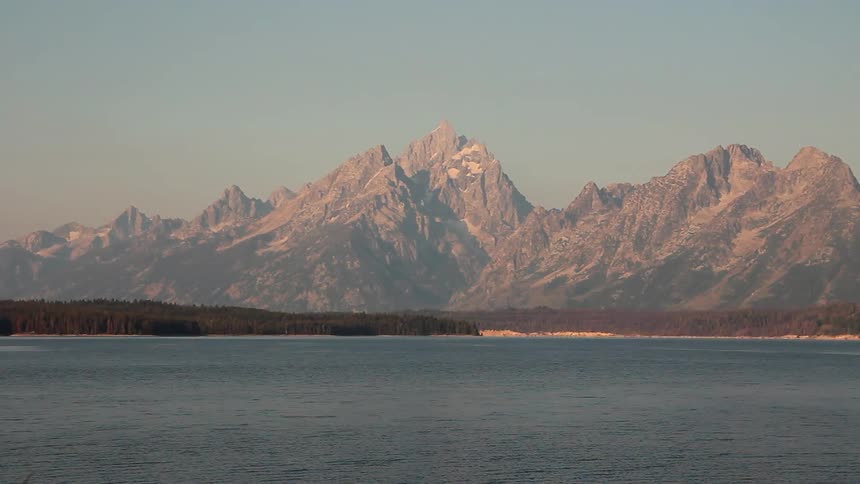 Water flowing with mountains in the background