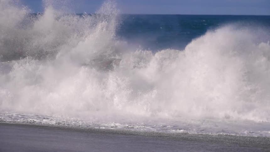 Waves crash onto a beach