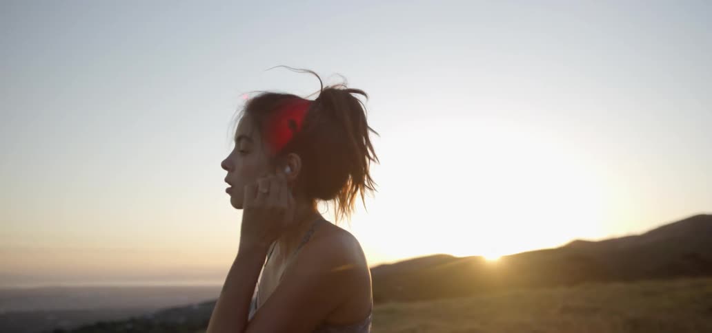 Woman jogs in nature at sunrise