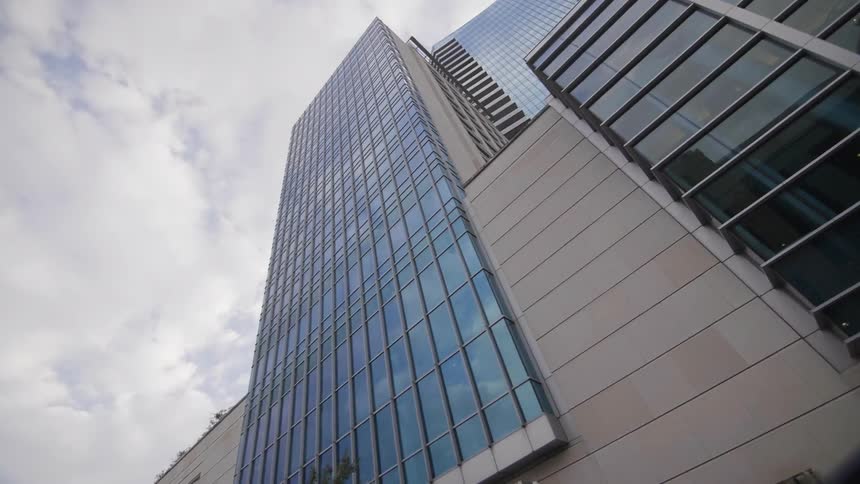 View looking up at a skyscraper on a cloudy day