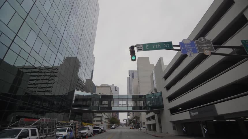 A pedestrian walkway between two buildings over a city street