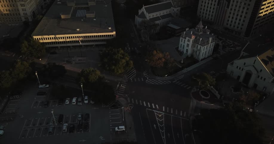 City buildings and a parking lot are shown