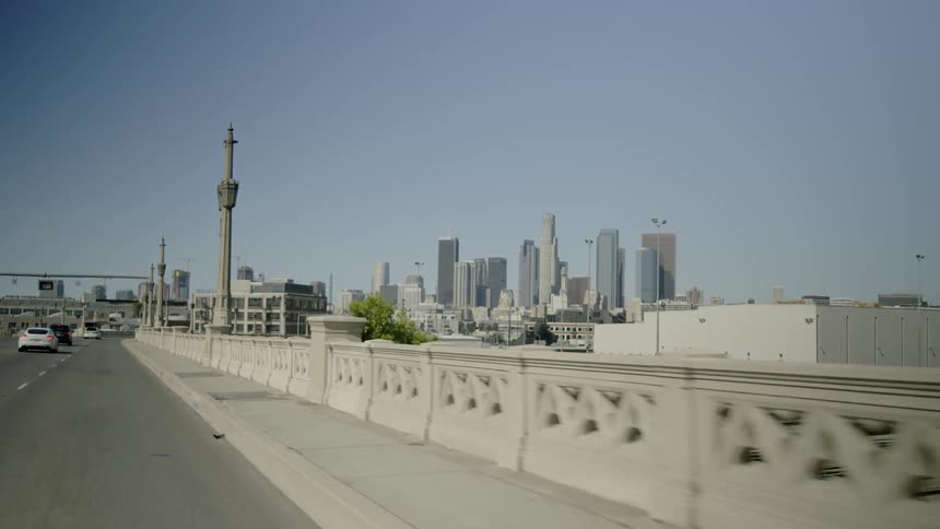 Cars travel on a highway towards a city